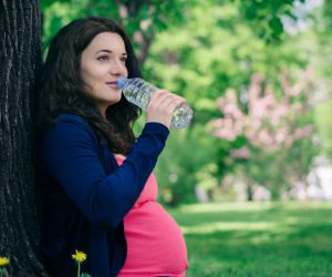 mom-to-be drinking water